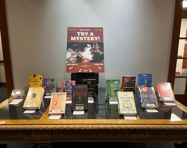 A mystery-themed display of print books.