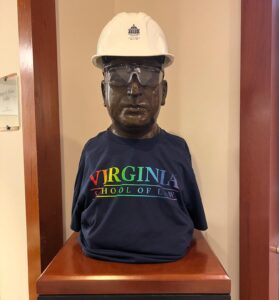 The Arthur bust sports a construction hat and a t-shirt that says "Virginia School of Law" in rainbow-colored letters.